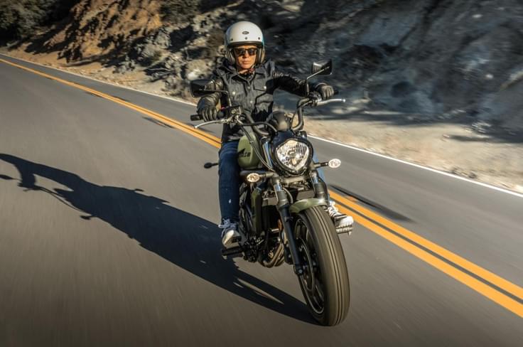 A long wheelbase and stretched stance give it traditional cruiser proportions Kawasaki Vulcan S riding shot